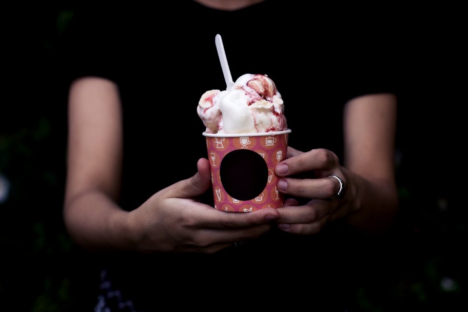 person holding bucket of ice cream