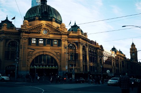 brown building with cars passing infront photo