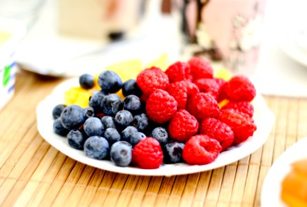 strawberries and blue berries on palte