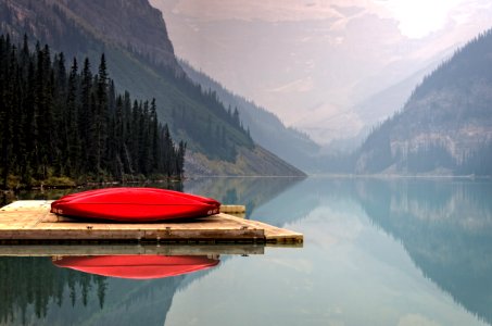 brown floater with red canoe in body of water photo