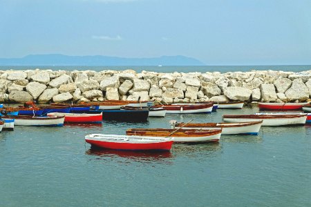 boats dock near the rocks photo