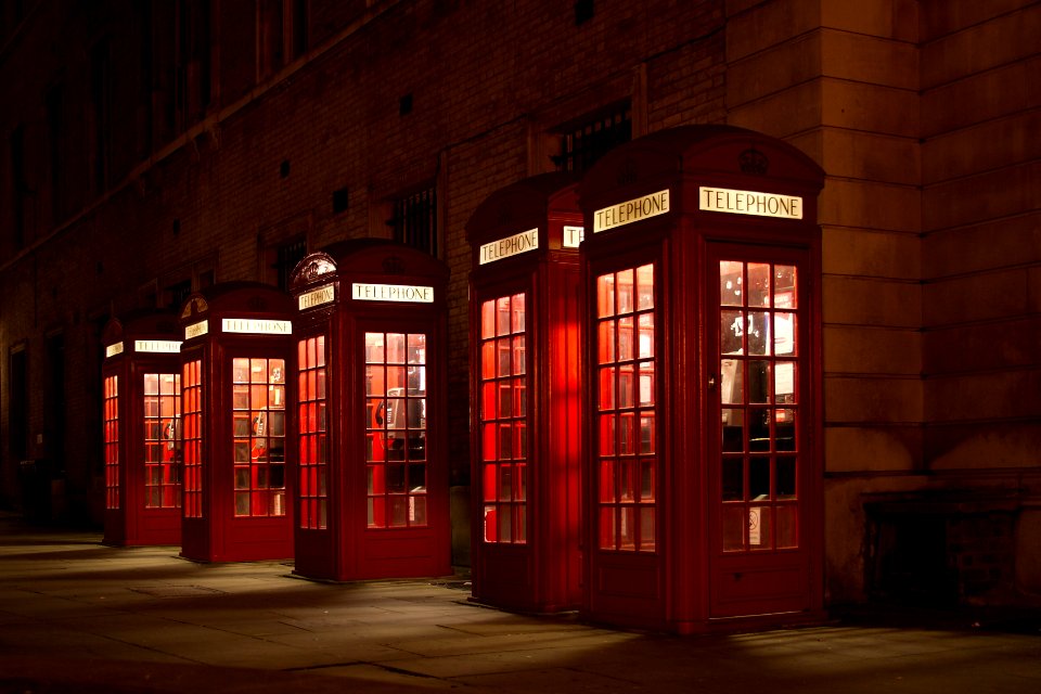 five red lined phone booths near building
