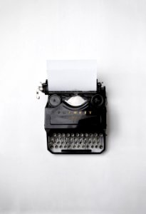 black Fayorit typewriter with printer paper photo