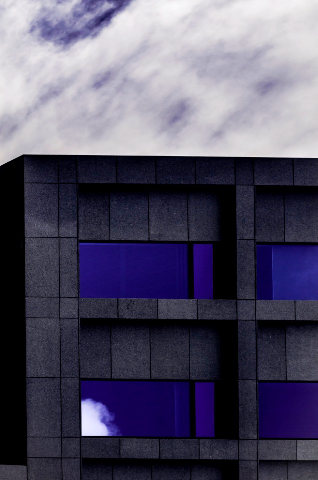 gray and purple concrete building under cloudy skyt
