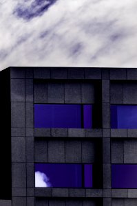 gray and purple concrete building under cloudy skyt photo