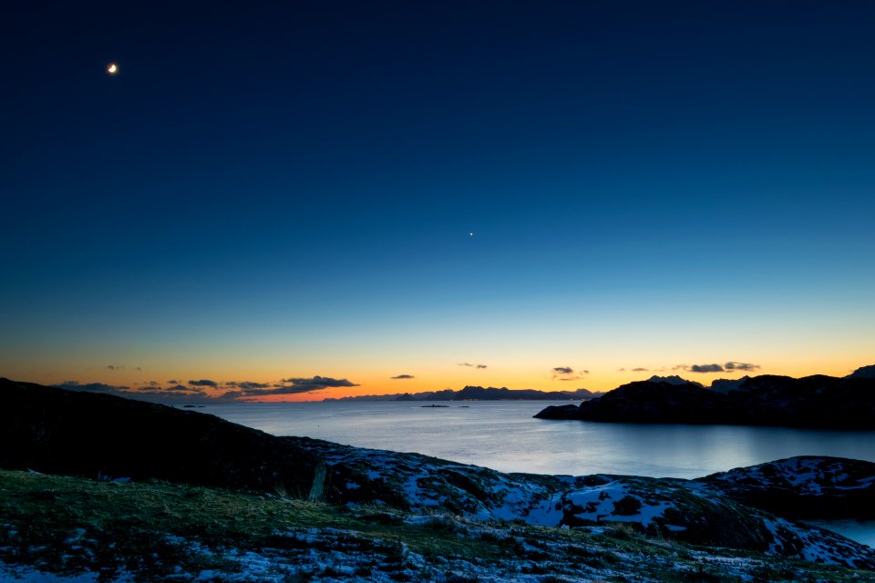 landscape photo of body of water in between land formations