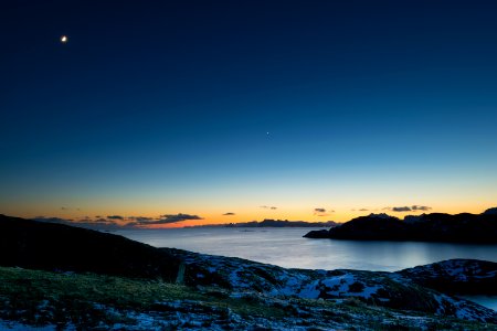 landscape photo of body of water in between land formations