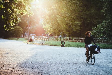 woman riding bicycle on park during daytime photo