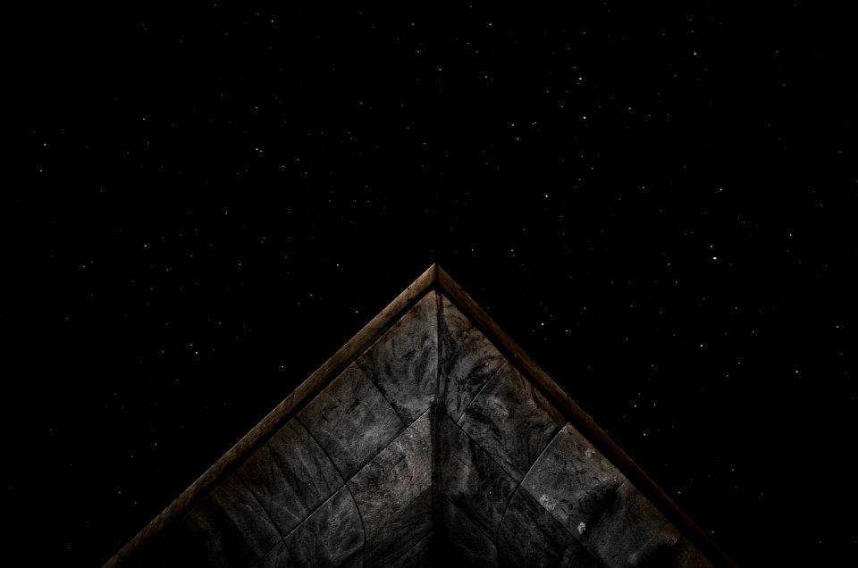 gray roof under starry sky at nighttime