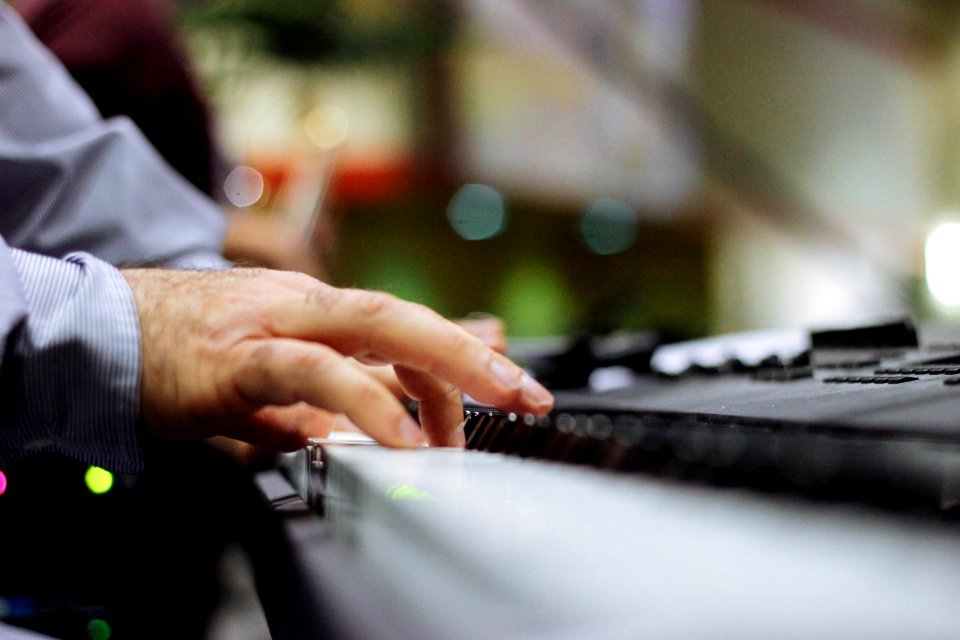 selective focus of person playing piano