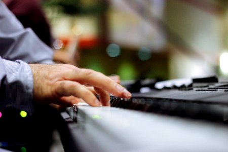 selective focus of person playing piano photo