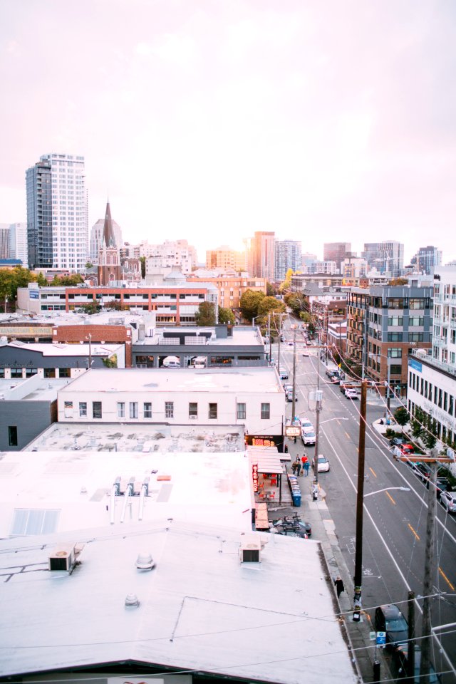 Rooftop shot of Capitol Hill road with city buildings and skyscrapers in background