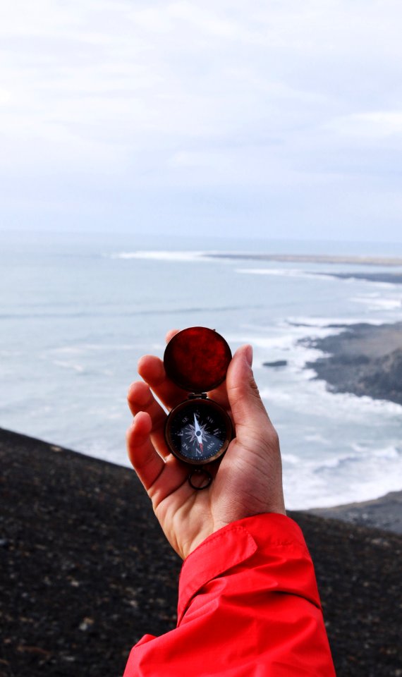 person holding compass