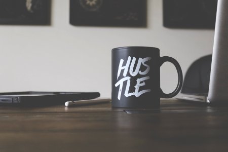 black and white Hustle-printed ceramic mug on table photo