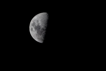 half moon on pitch dark sky photo