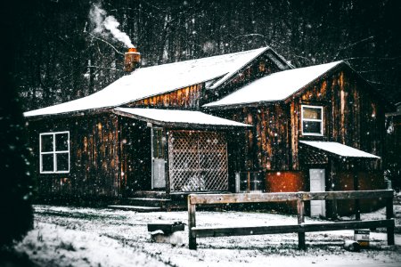 brown wooden house covered by snow photo