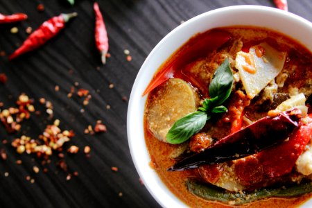 flat-lay photography of vegetable soup on white ceramic cup