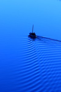 man riding on boat on body of water photo