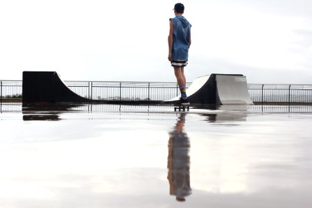 man standing on skateboard near ramp photo