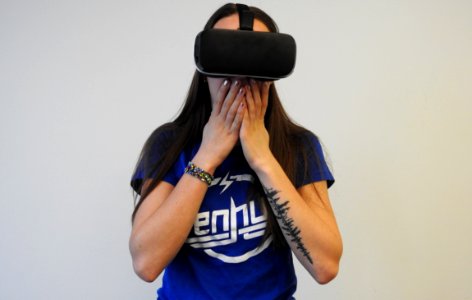 woman using black VR headset photo