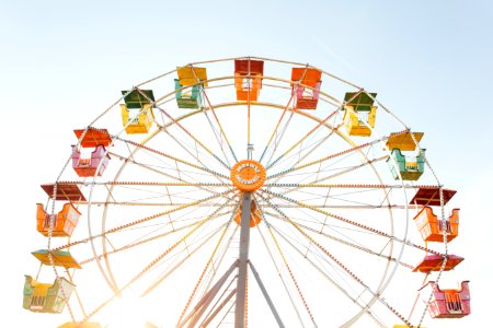 worm's eye view of red, orange, and yellow Ferris wheel photo