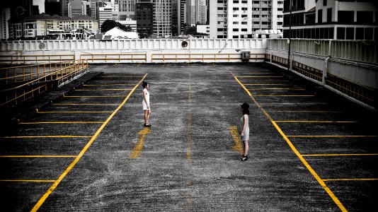 two woman in parking lot photo
