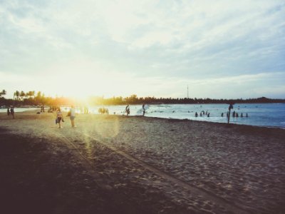 people walking on seashore during daytime photo