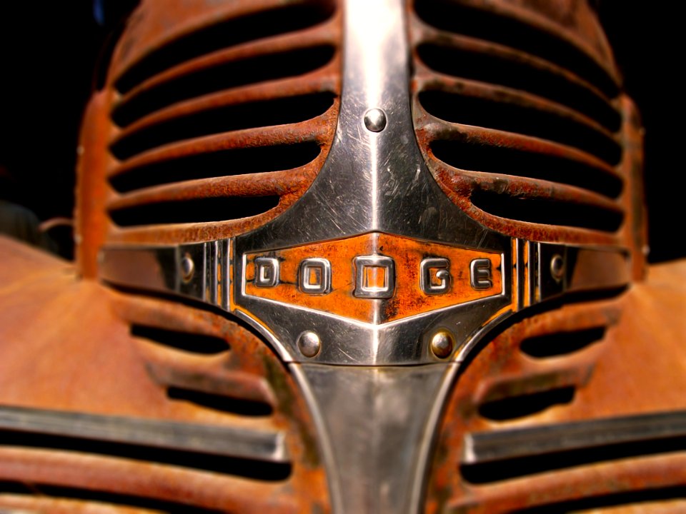 Rusty chrome grille of old dodge car.