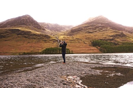 person taking photo of mountain photo