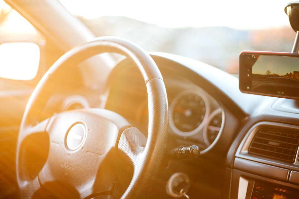 closeup photo of black car steering wheel