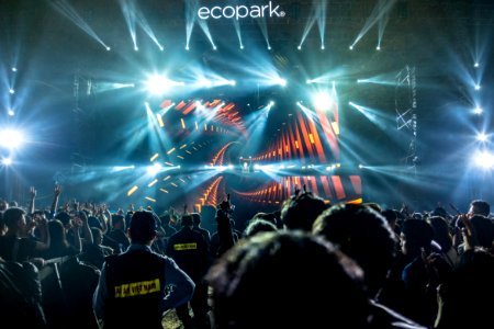 people standing in front of Eco Park stage photo