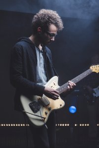 man playing with electric guitar photo
