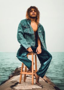 man sitting on brown wooden stool