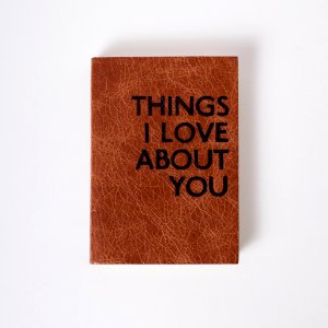 A brown book with black writing that says "Things I love About You." photo