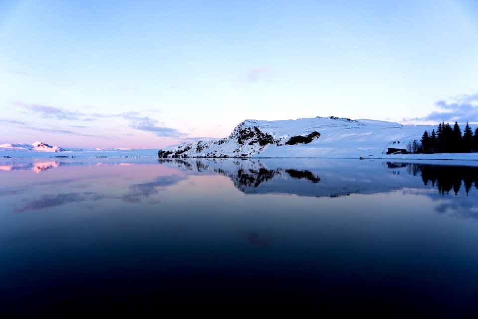 wide angle photo of body of water under blue sky