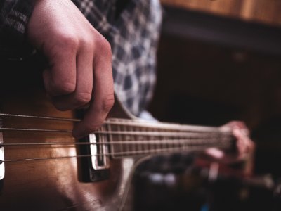 person playing acoustic guitar photo