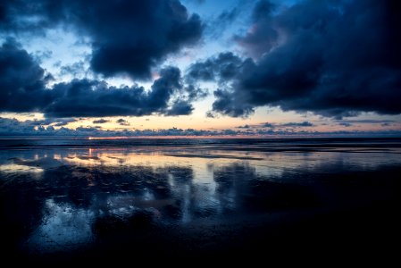 calm body of water under dark clouds