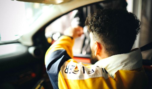 A male driver is making payment at the toll booth in Dresden.