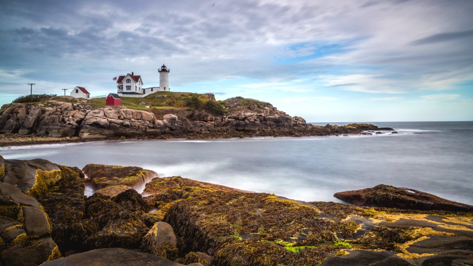 white lighthouse on mountain during daytim photo