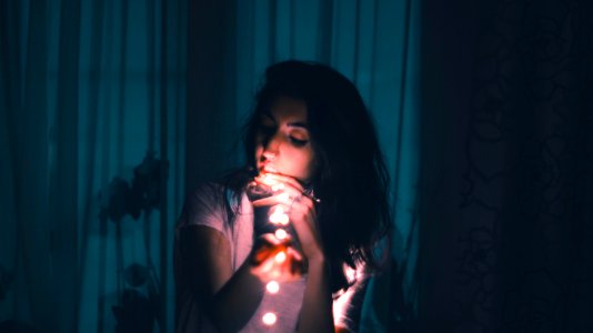 woman holding LED string light