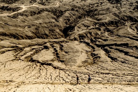 brown mountain range with two people photo