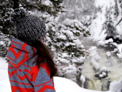 woman standing on snow field near trees photo