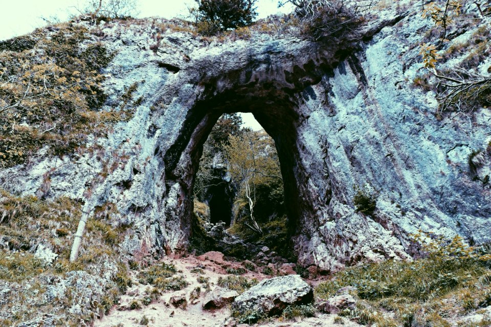 green grass covered rock formation at daytime