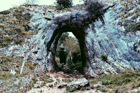 green grass covered rock formation at daytime