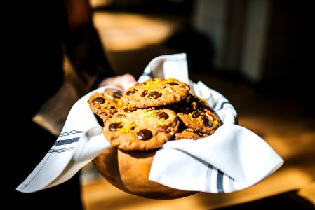 shallow focus photography of cookies on bowl with towel photo