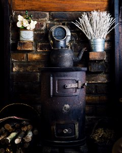 cast-iron teapot on wood burner photo