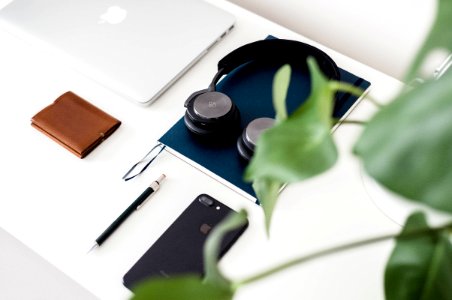black and gray headphones on blue book photo