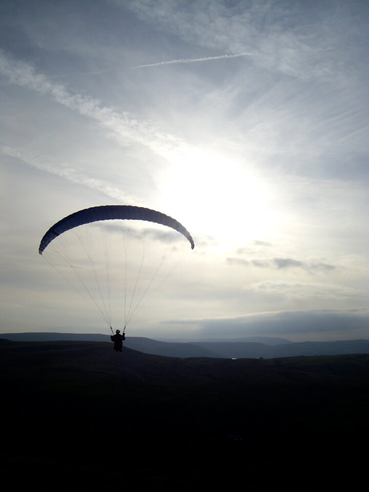 Paragliding flying sunset