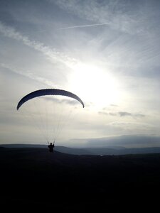 Paragliding flying sunset