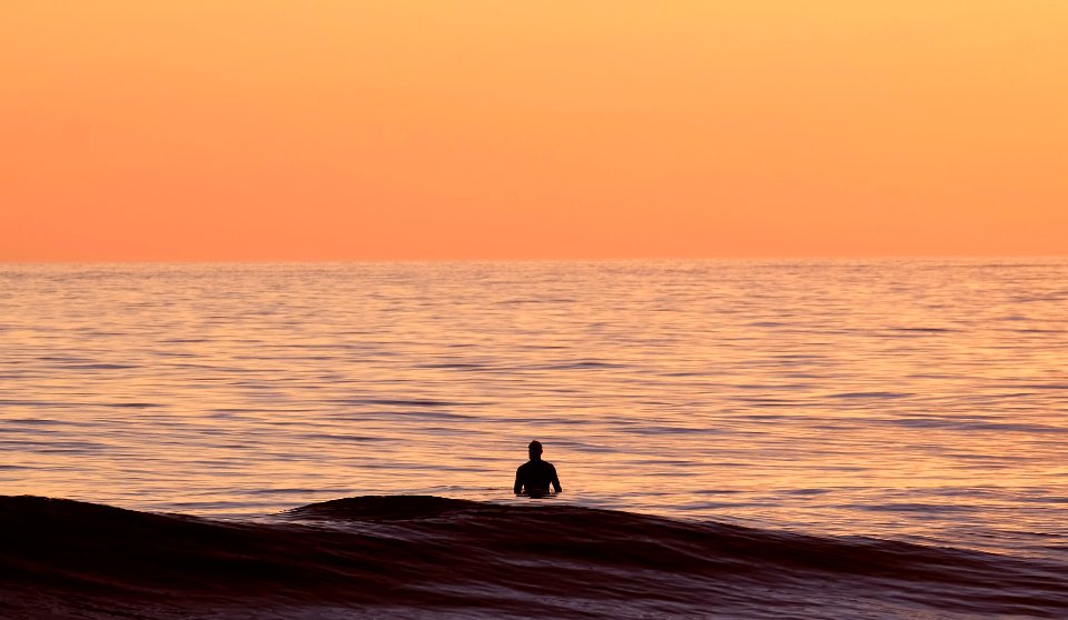 silhouette of person in body of water photo